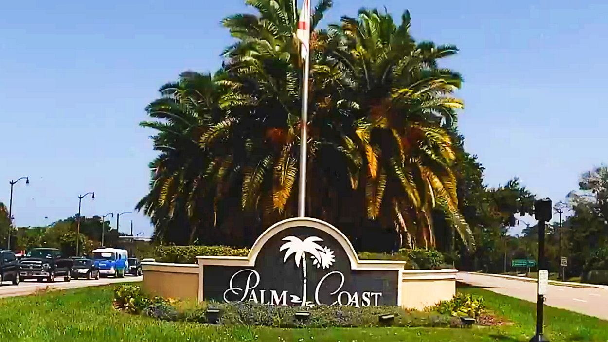 Palm Trees with a sign that says 'Welcome to Palm Coast'