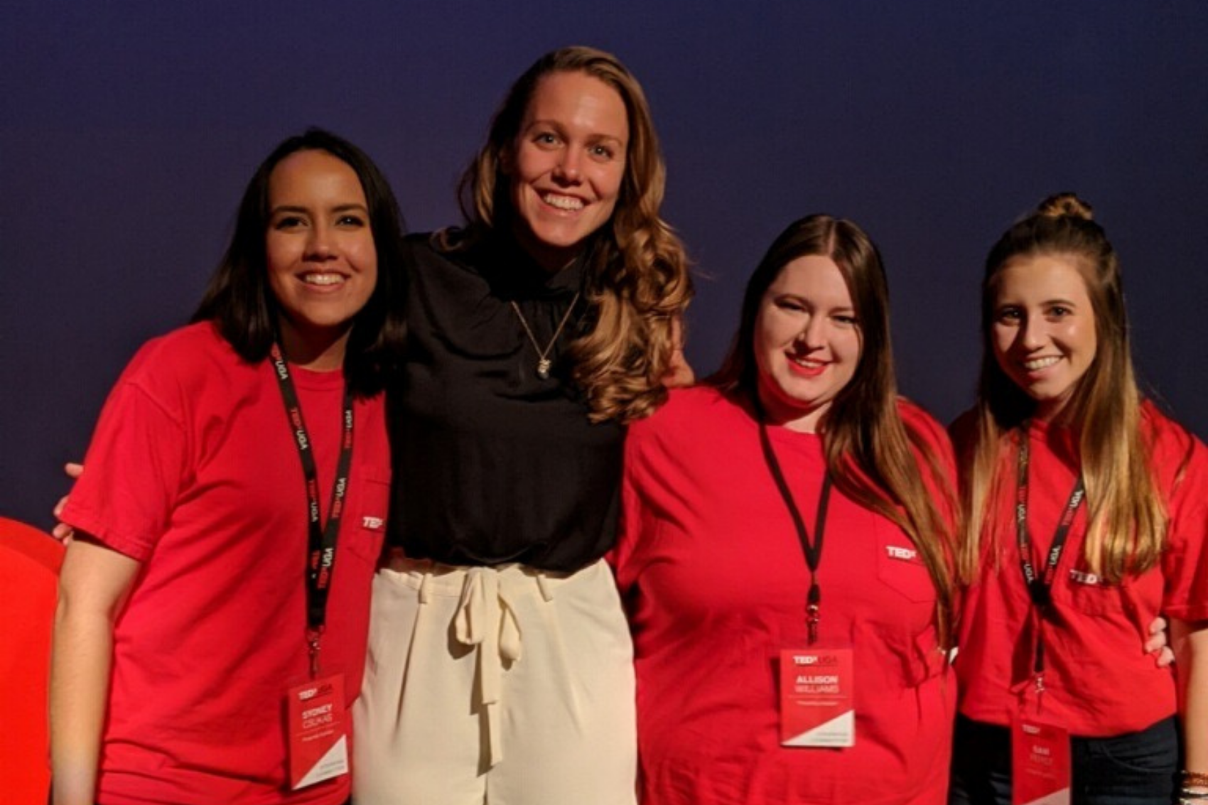 Four women in red shirts